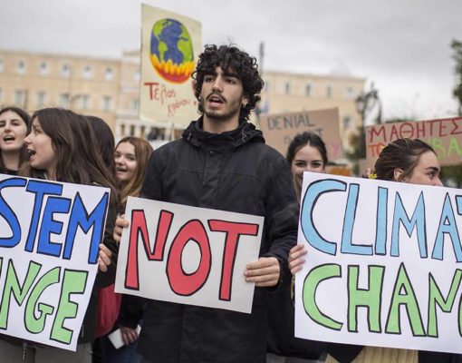 15 March 2019, Greece, Athen: Students hold "System Change Not Climate Change" signs at a "Fridays for Future" rally against climate change. More than 1650 demonstrations in around 100 countries worldwide are expected on this day. Photo: Socrates Baltagiannis/dpa (Photo by Socrates Baltagiannis/picture alliance via Getty Images)