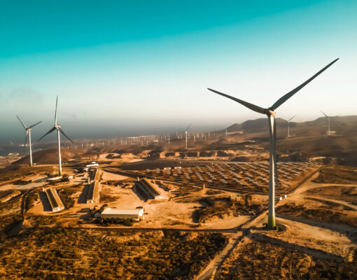 Panoramic view of wind turbine and solar panels in background - Sustainable environment concept